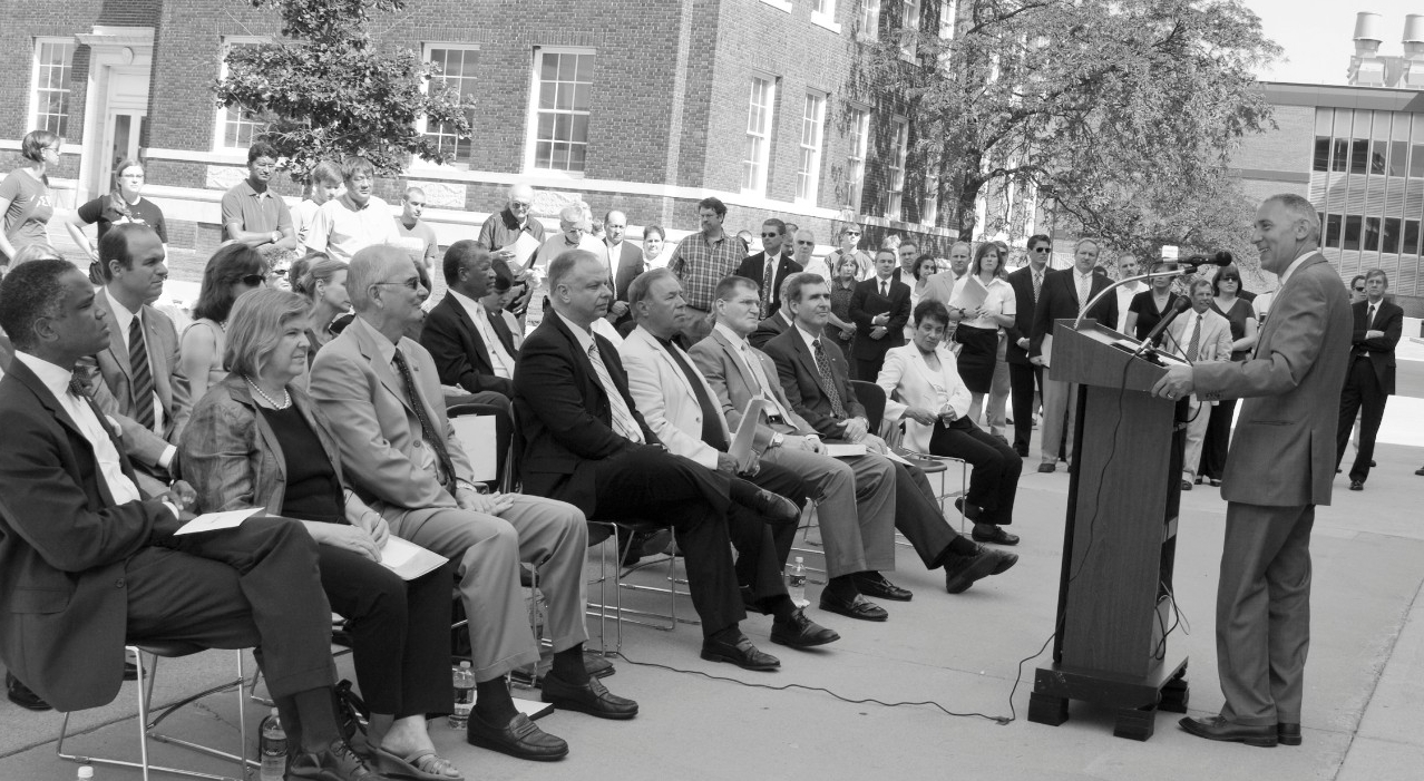 Man addressing a seated crowd