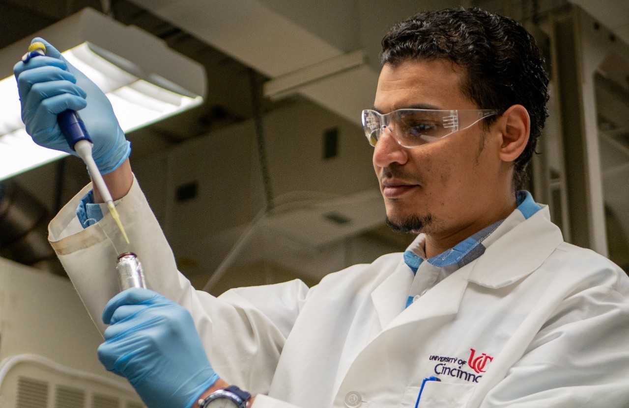 A student using a pipet in a lab