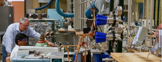 Professor assisting student in a lab