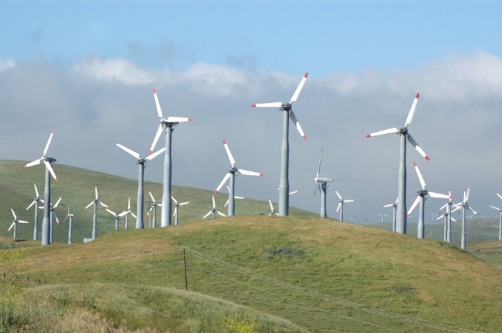 Open, hillside field with windmills
